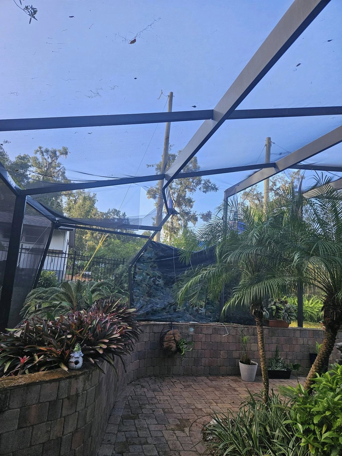 Storm-damaged screen material staged for repair after hurricane in Central Florida