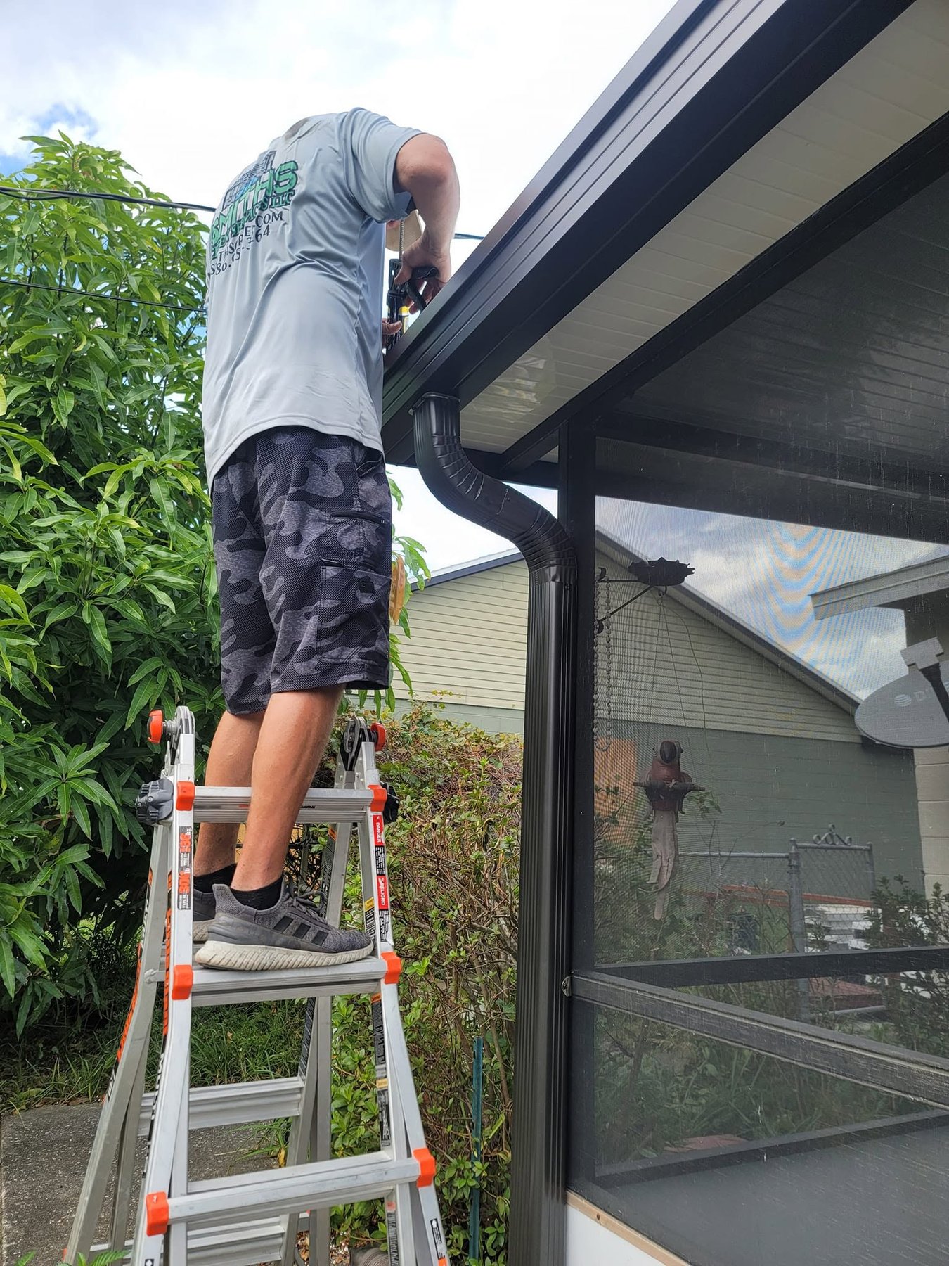 Technician installing heavy-duty Super Gutter system on Florida home